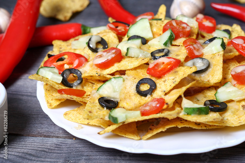 Mexican hot nachos with vegetables and chili
