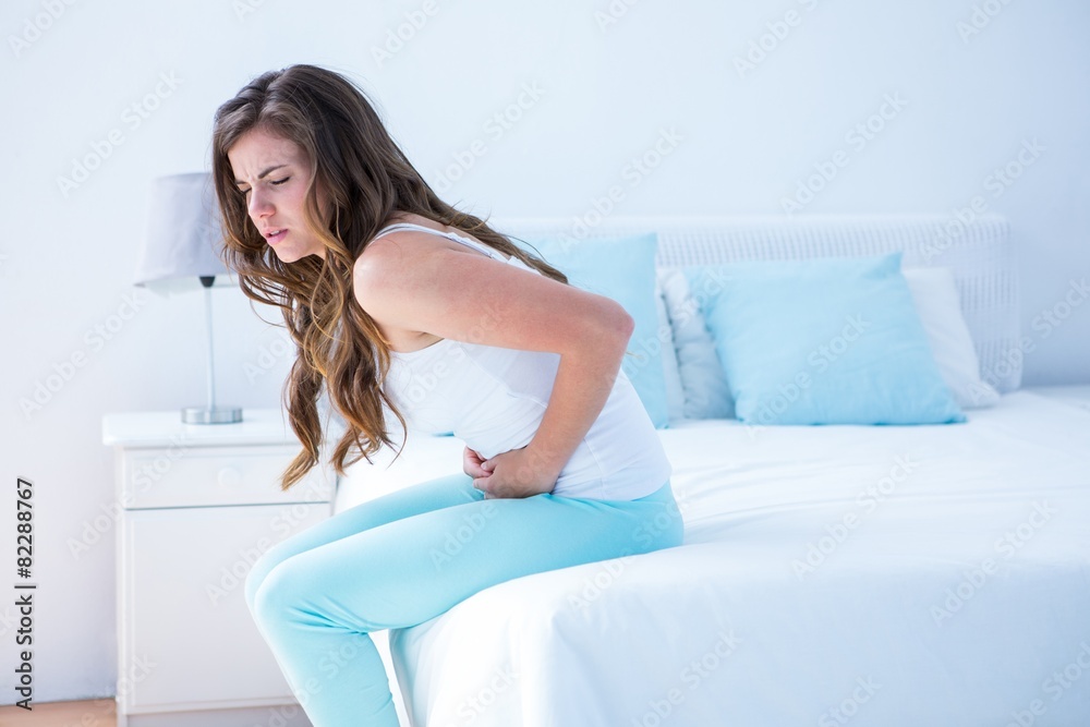 Pretty woman suffering from stomach pain Pretty woman suffering from stomach pain
