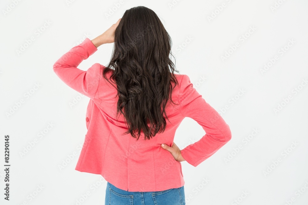 Elegant brunette standing back to camera and looking away Elegant brunette standing back to camera and looking away