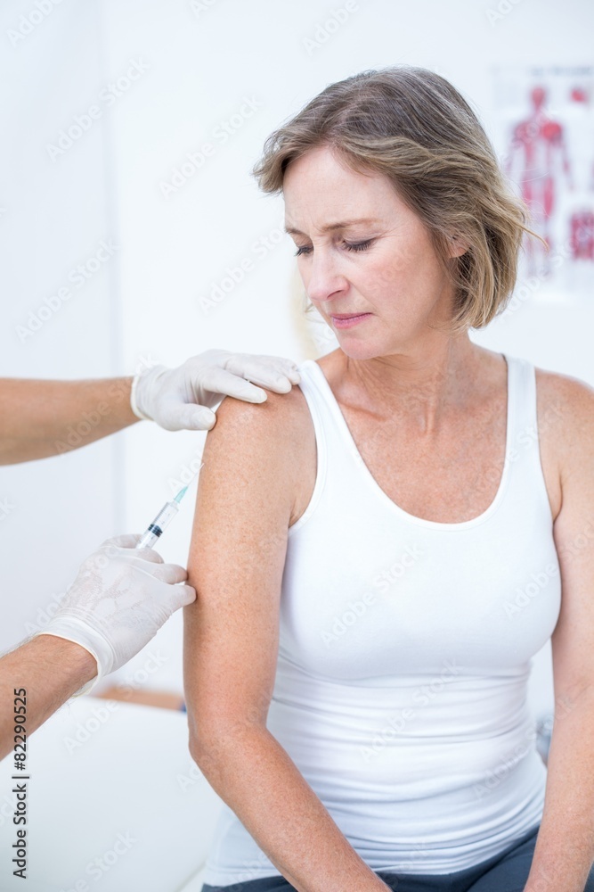 Doctor doing an injection to his patient