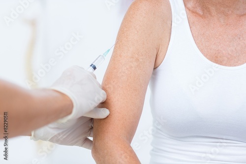 Doctor doing an injection to his patient