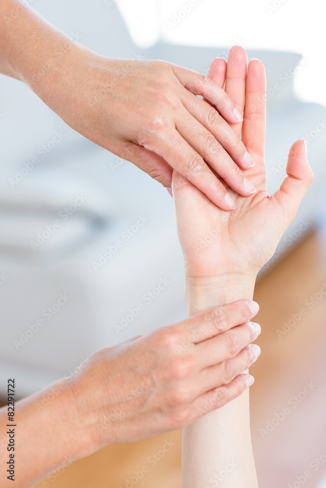 Fototapeta premium Physiotherapist examining her patients hand