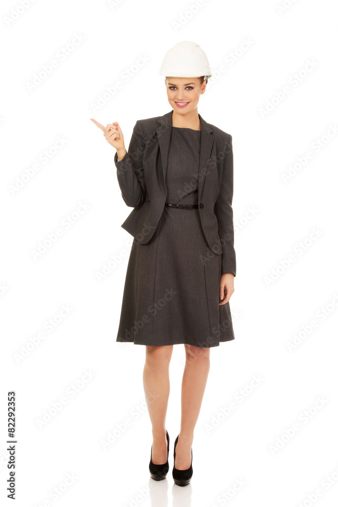 Young businesswoman pointing up. Young businesswoman pointing up.