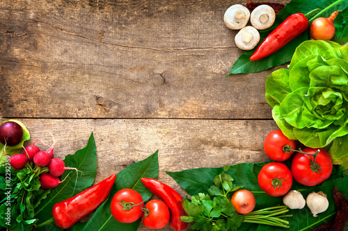 Fresh ripe vegetables on wooden table background