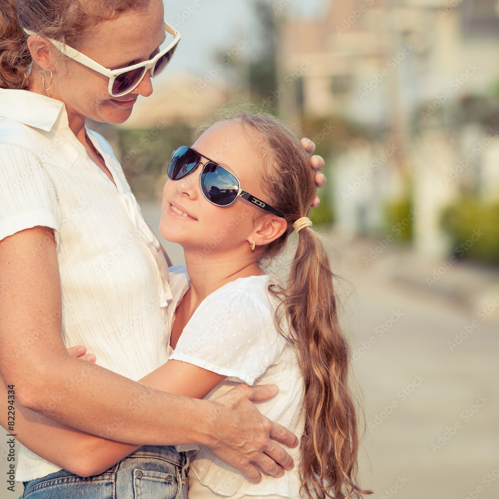 Mother and daughter standing on the road at the day time. Mother and daughter standing on the road at the day time.