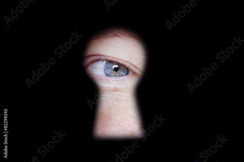 eye looking at you through door keyhole