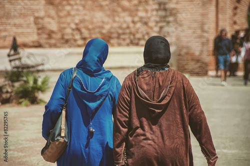 Two moroccan women dressed in typical djellaba photo
