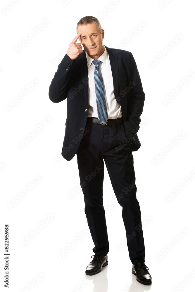 Businessman gesturing idiot sign Businessman gesturing idiot sign