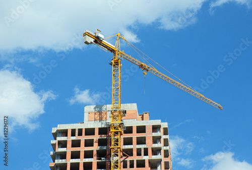 Building crane with clouds and blue sky background
