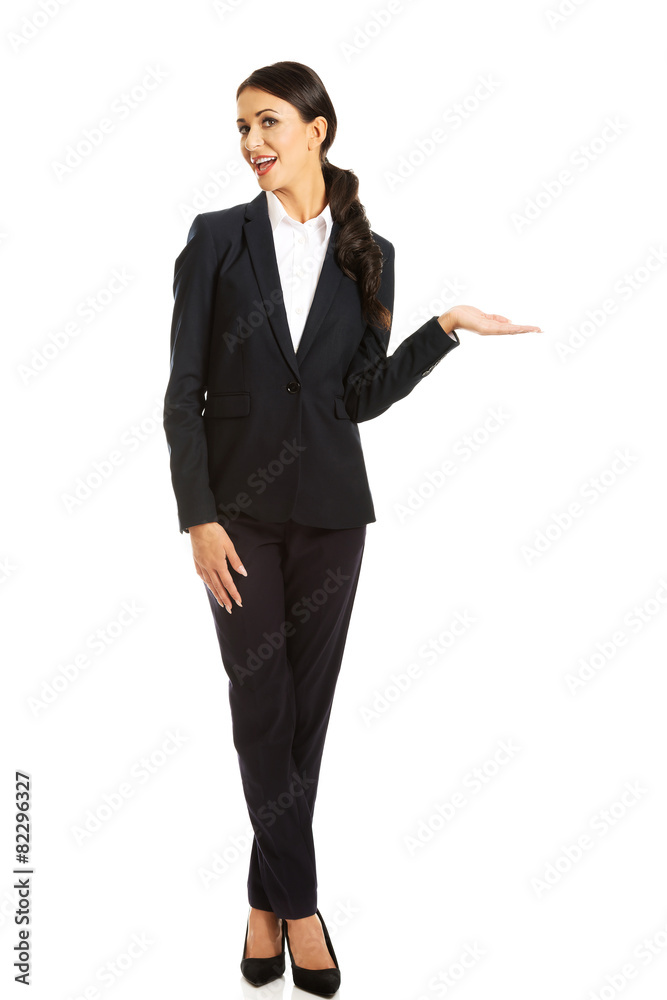 Businesswoman holding copyspace on the left hand Businesswoman holding copyspace on the left hand