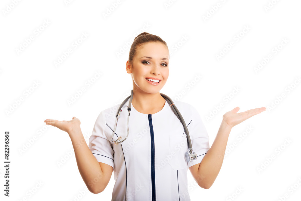 Female doctor presenting copyspace in both hands