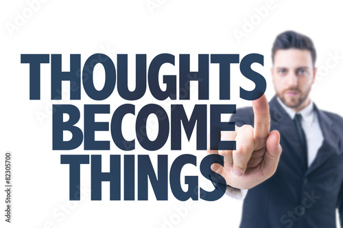 Business man pointing the text: Thoughts Become Things