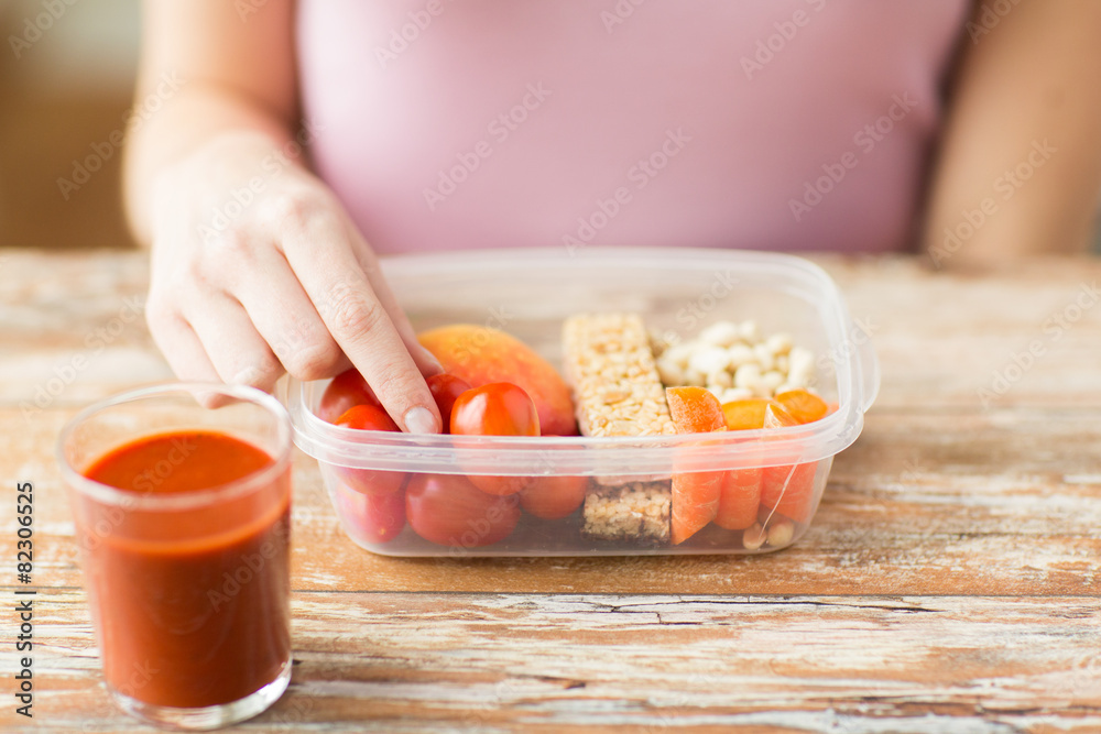 close up of woman with vegetarian food in box close up of woman with vegetarian food in box