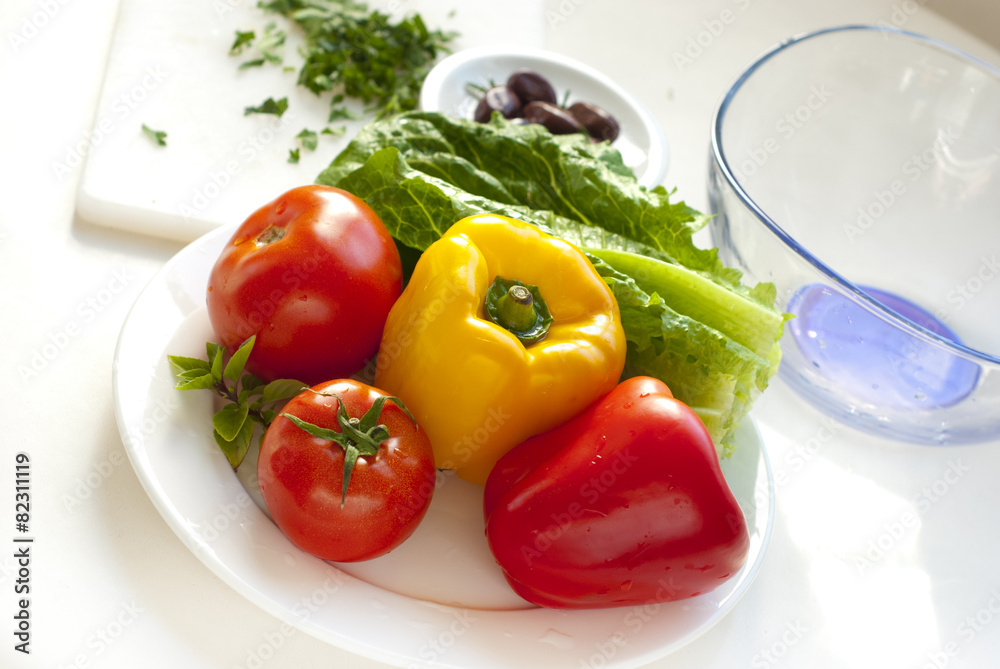 raw vegetables for salad on white plate raw vegetables for salad on white plate