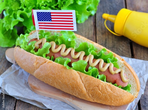 hotdog sandwich with yellow mustard sauce and lettuce