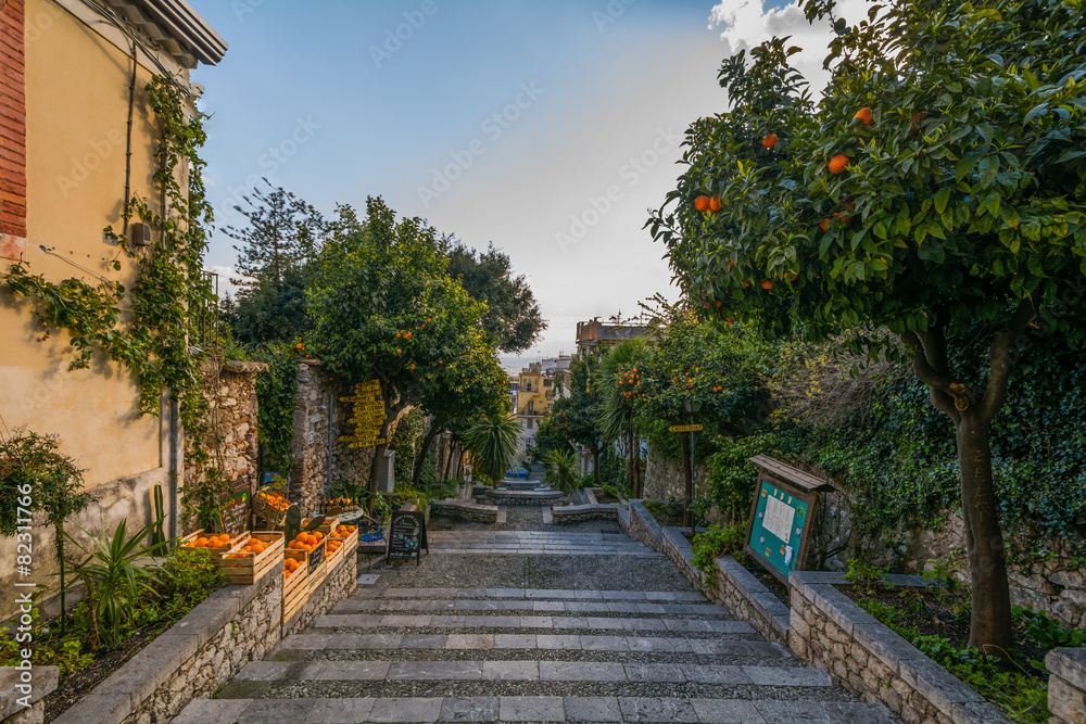 Street in Taormina with orange trees on the side Sicily, Italy