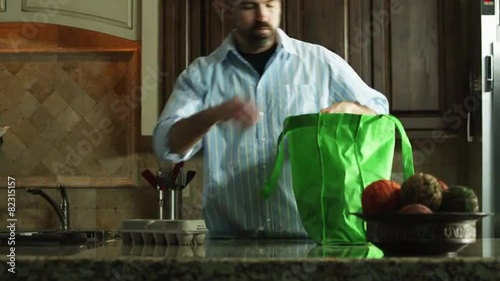 MS TU Man unloading grocery bag in kitchen / Orem, Utah, USA