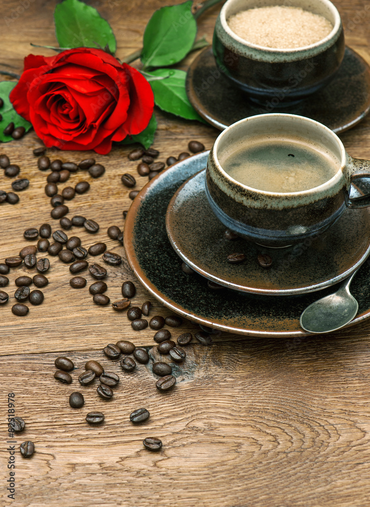 Cup of coffee and red rose flower. Festive table setting Cup of coffee and red rose flower. Festive table setting