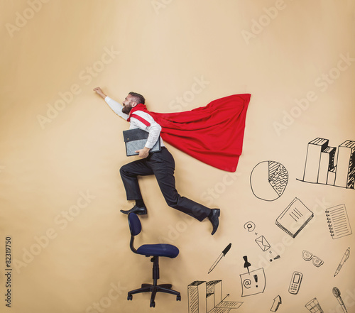 Obraz na płótnie Manager in a cloak of superman. Studio shot on beige background