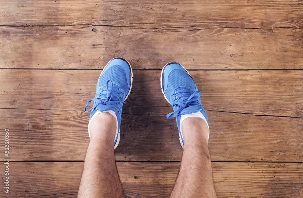 Legs of a runner on a wooden floor background Legs of a runner on a wooden floor background