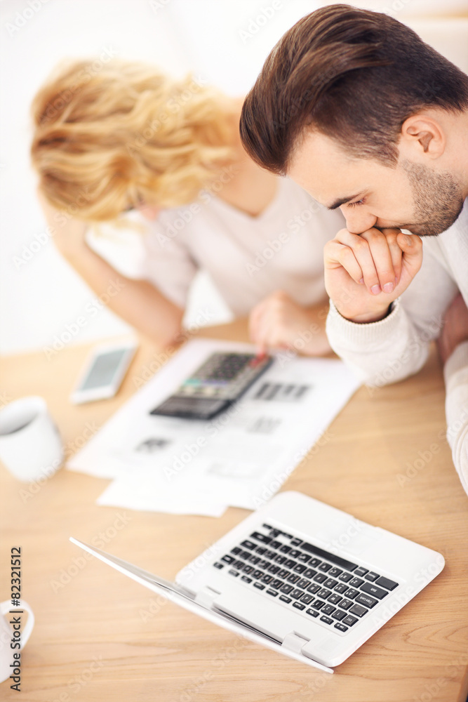 Worried couple with documents at home Worried couple with documents at home