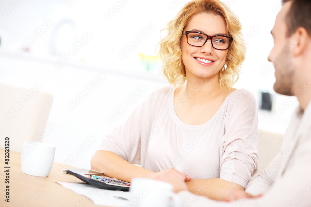 Young happy couple working on home budget Young happy couple working on home budget