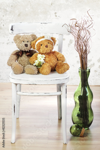 Two in love teddy bears sit on a chair. Wedding  concept photo