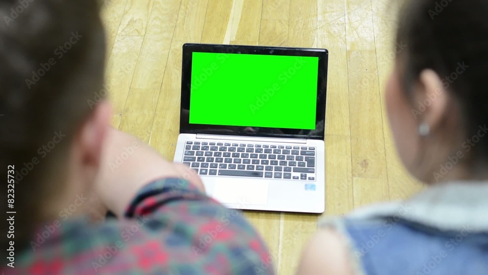 two friends work on notebook - green screen - man and woman