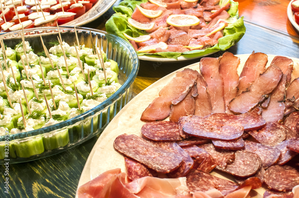 Sliced sausages and cocktail bites in dishes