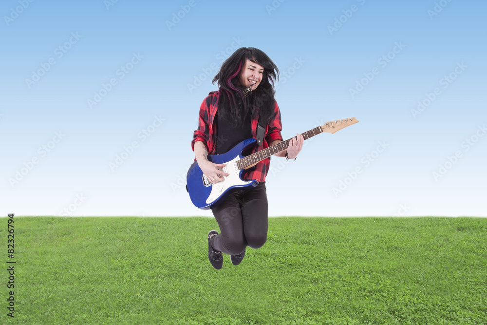 young man jumping with electric guitar