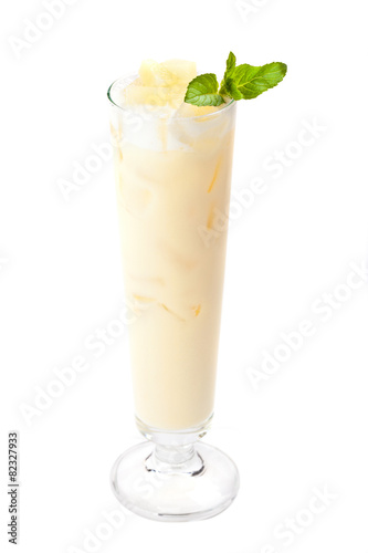 Cocktail Pina Colada in a tall glass garnished mint leaf. Isola