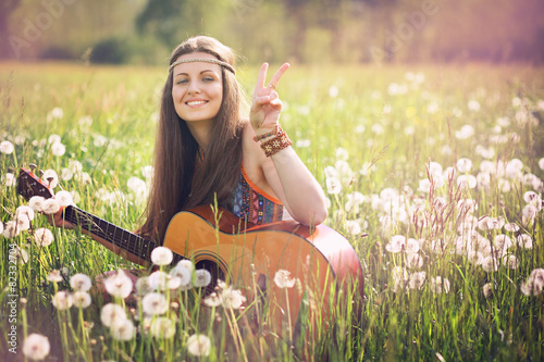 Fotografie Smiling hippie woman giving peace sign