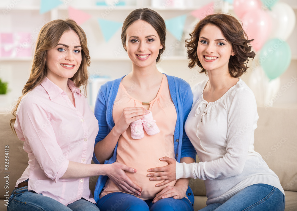 Friends visiting pregnant woman Friends visiting pregnant woman