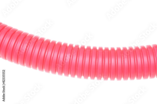 Red plastic corrugated pipe on white background