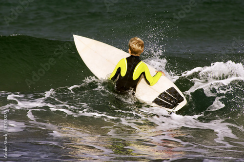 boy surfer waiting for the waves on Sabon beach Corunna Spain photo