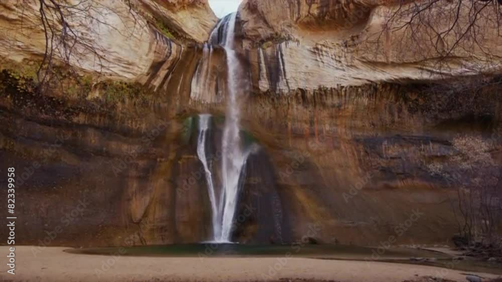 Panning medium shot of cliff wall and Lower Calf Creek Falls / Lower Calf Creek Falls, Utah, United States, 