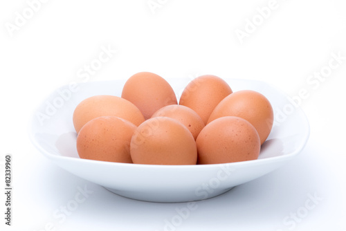 Eggs in dish on white background