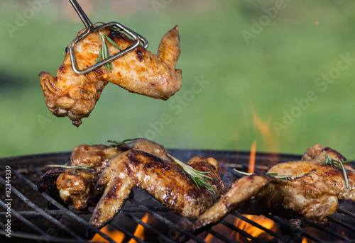 Delicious chicken wings on garden grill