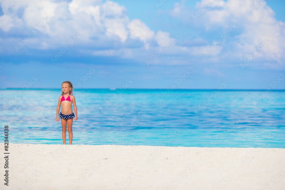 Adorable little girl at beach during summer vacation Adorable little girl at beach during summer vacation