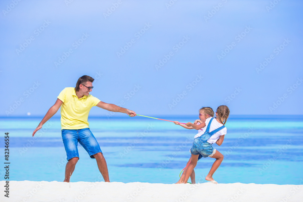Young father and little girls have fun together during tropical