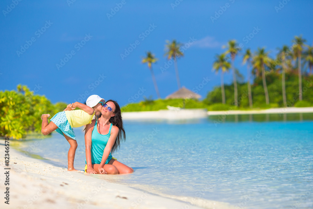 Mother and daughter enjoying time at tropical beach