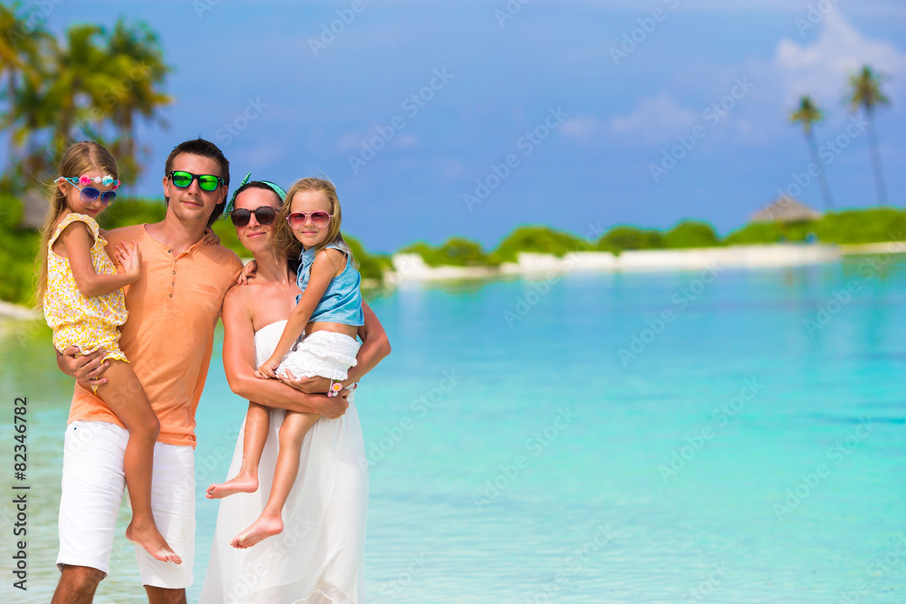 Happy family of four on beach vacation Happy family of four on beach vacation