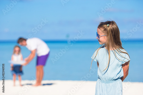 Young father and little girls have fun together during tropical