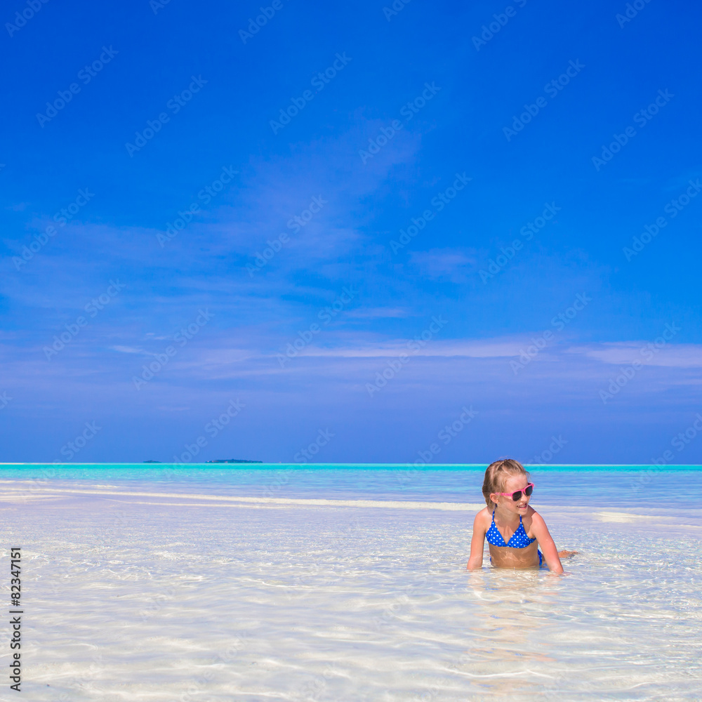 Adorable little girl at beach during summer vacation Adorable little girl at beach during summer vacation