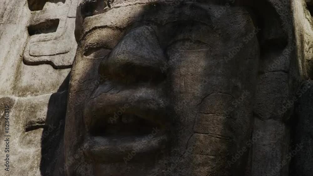 Close up panning shot of stone face at Mask Temple / Mask Temple, Lamani, Belize, Close up panning shot of stone face at Mask Temple / Mask Temple, Lamani, Belize,