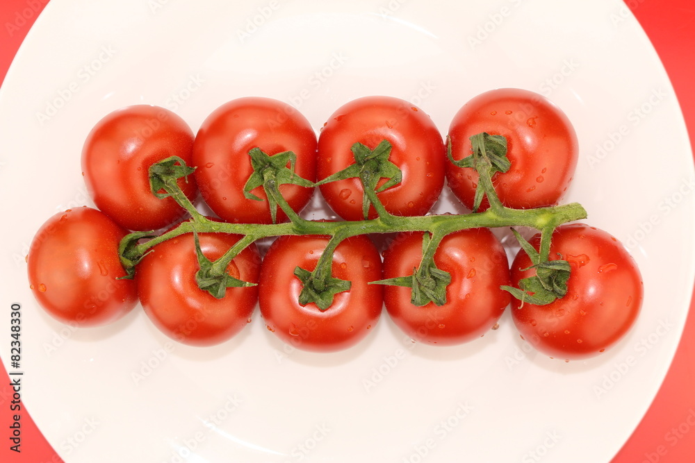 Isolated cluster of fresh ripe red cherry tomatoes Isolated cluster of fresh ripe red cherry tomatoes