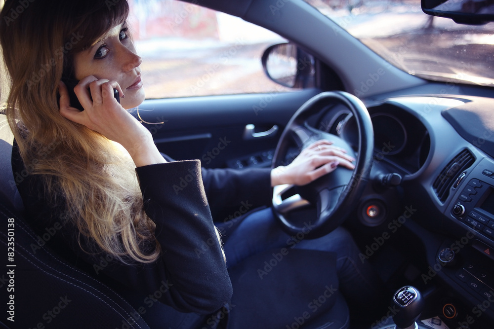 portrait of a girl in a car driver at the wheel