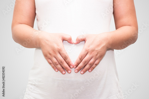 Wallpaper Mural Pregnant Belly with fingers Heart symbol.(Clipping path) Torontodigital.ca