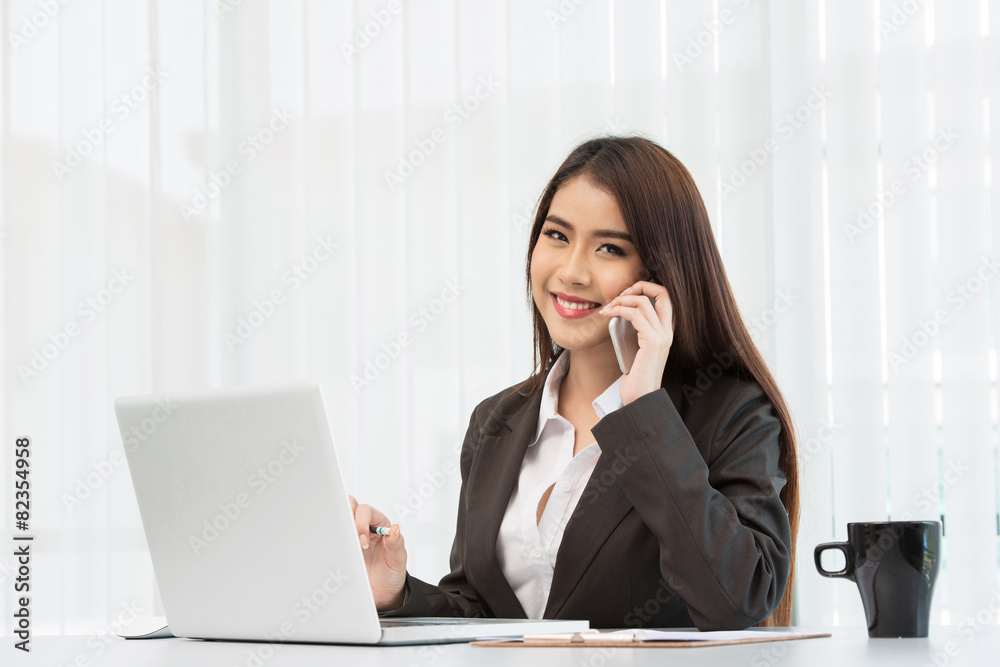 Portrait of a young business woman using laptop at office Portrait of a young business woman using laptop at office