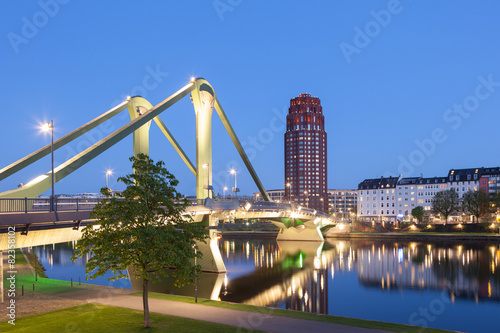 Floesser bridge illuminated at night in Frankfurt, Germany photo